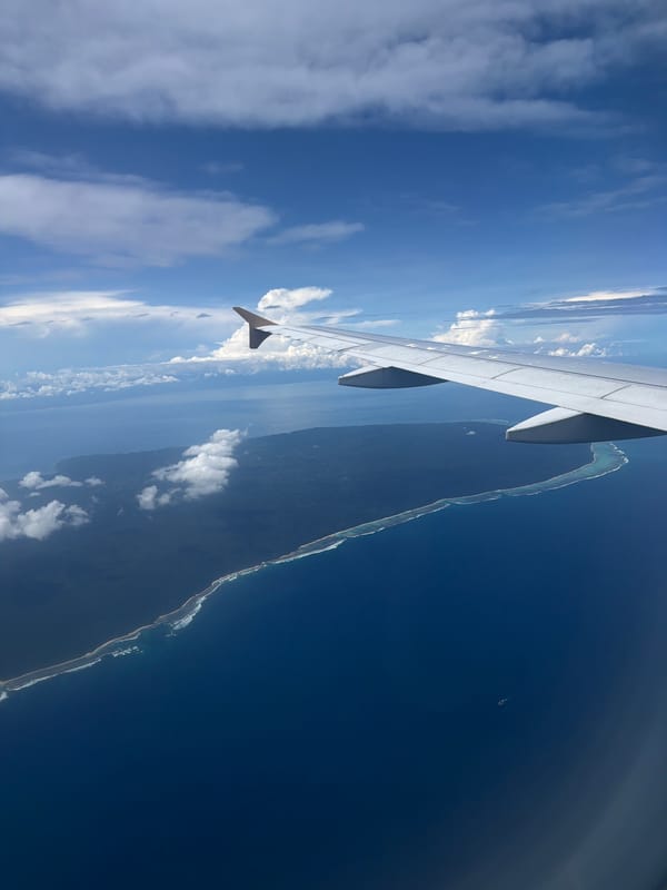 Passenger photographs aircraft wing over Indonesian waters during flight