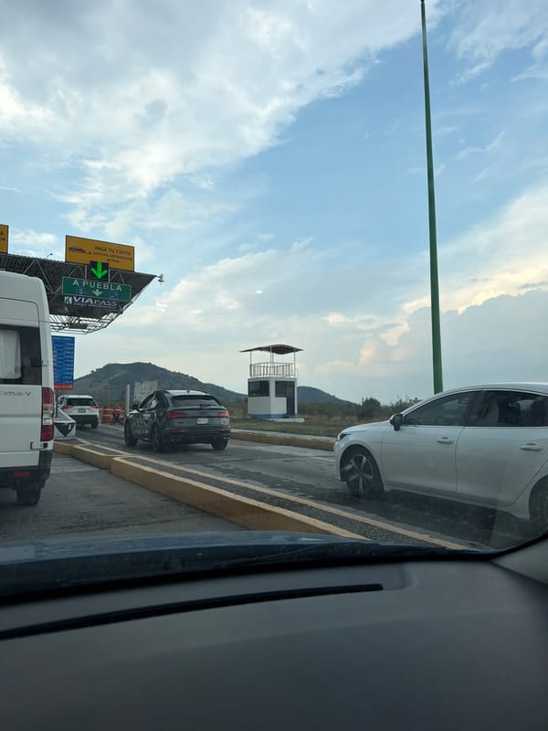 Driver passes through Metepec toll plaza listening to music