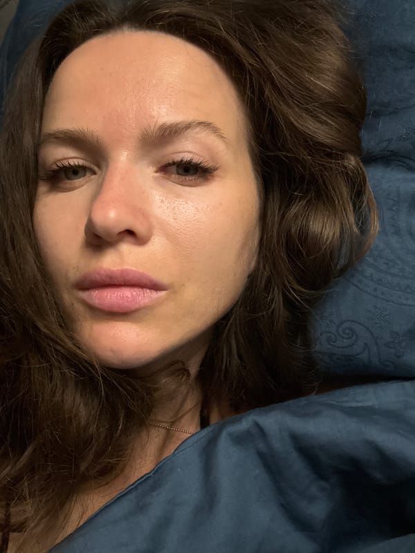 Portrait photograph captured of woman on blue bedding in Khimki
