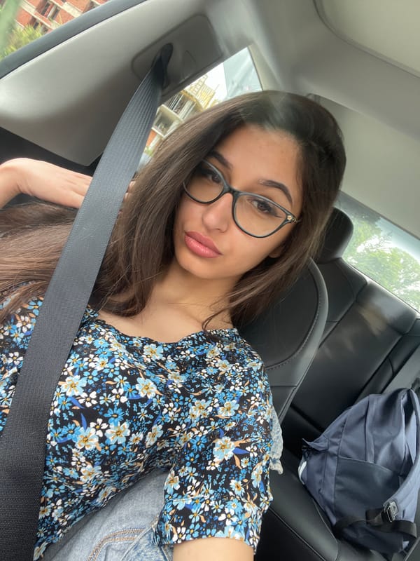 Woman in floral top travels by car in Velingrad