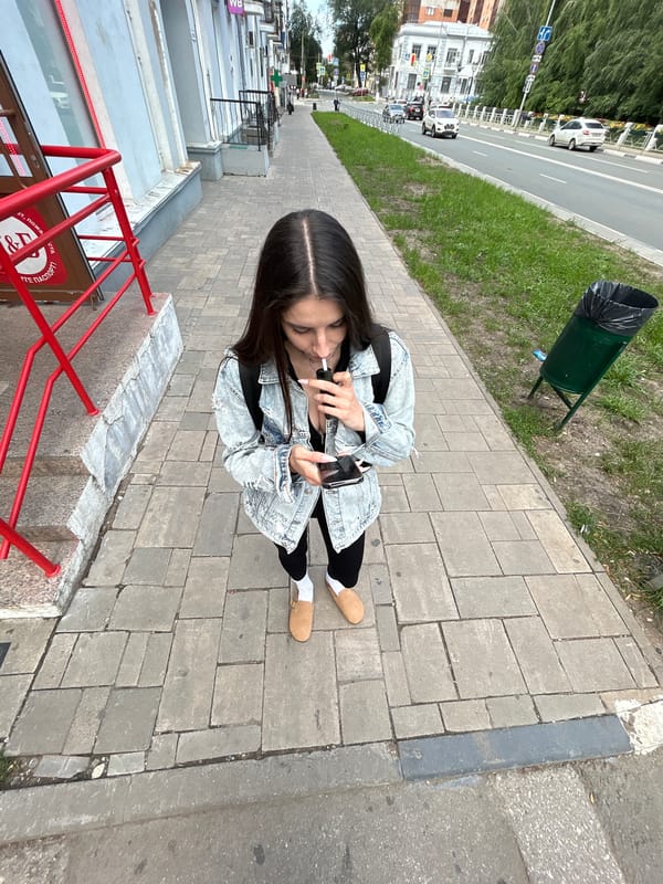 Vaping and scrolling on a Novokuybyshevsk sidewalk