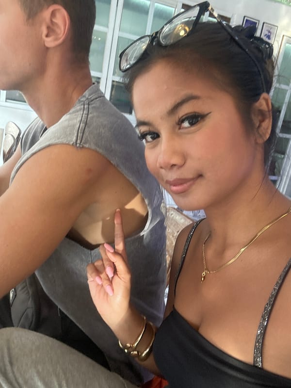 Two women take selfies together in Sukawati, Indonesia