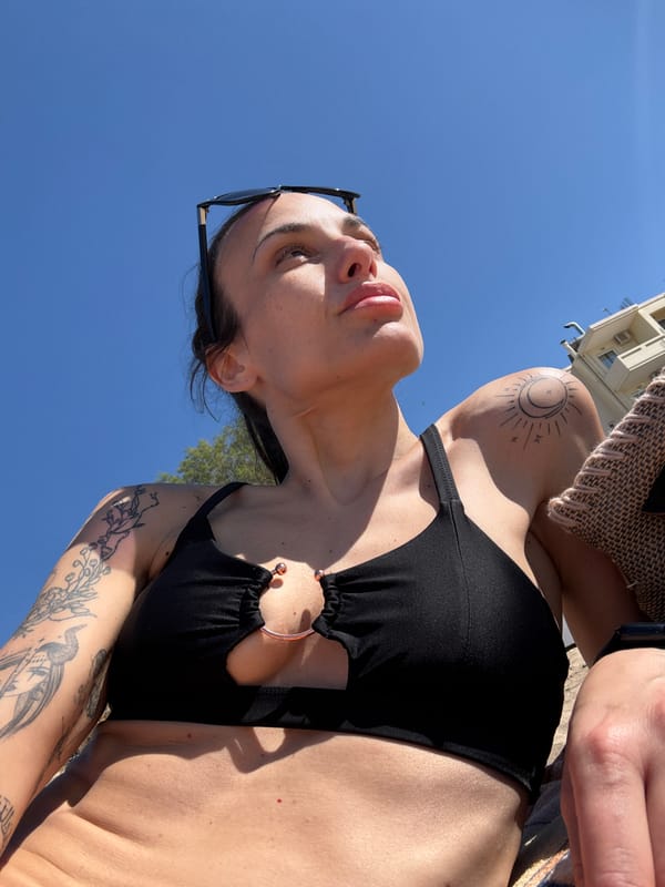 Woman enjoys sunny beach day in Chania, Greece