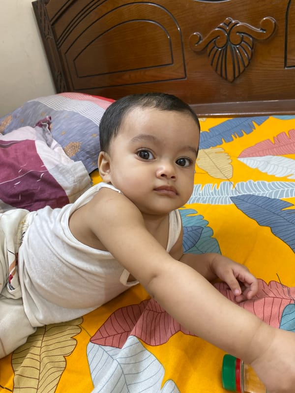 Baby photographed in multiple poses during indoor session in Dhaka