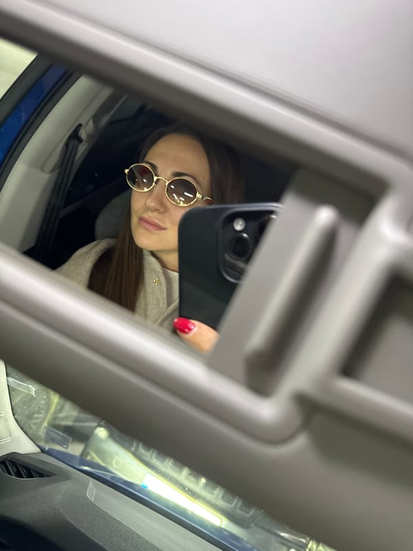 Woman takes car mirror selfies in Varna, Bulgaria