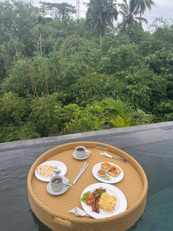 Floating breakfast served poolside in Tegallalang rainforest setting