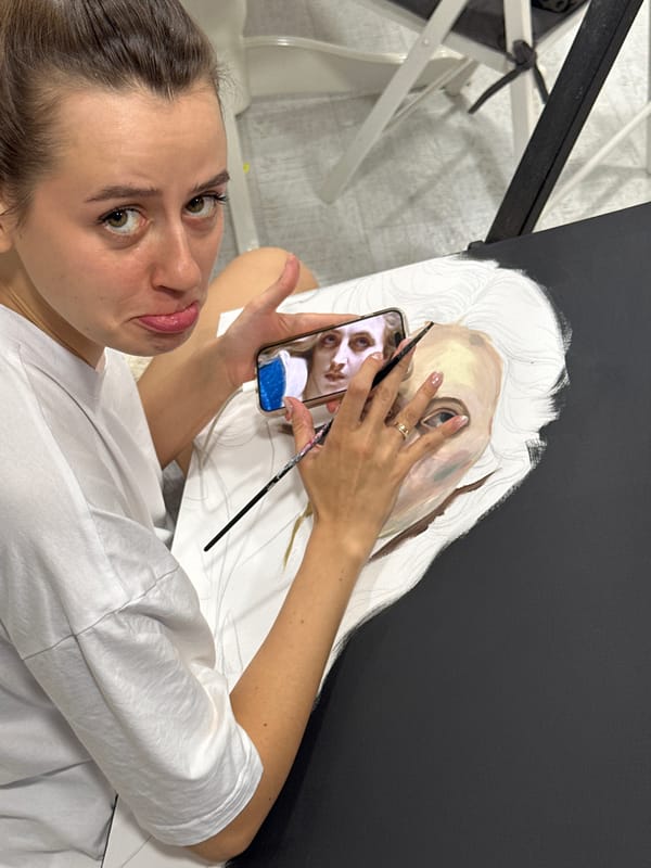 Artist paints portrait using phone reference in Krasnoyarsk