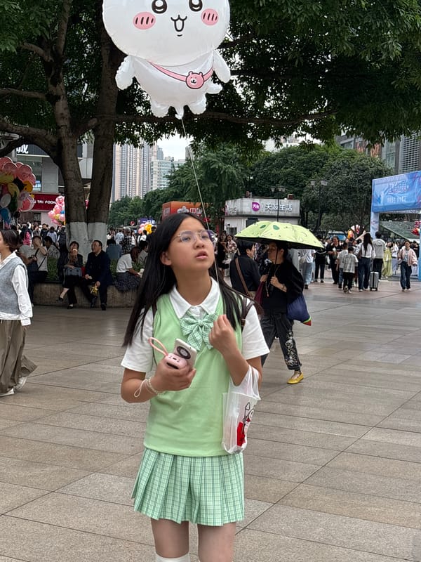 Student with pink camera photographed in Chongqing public space