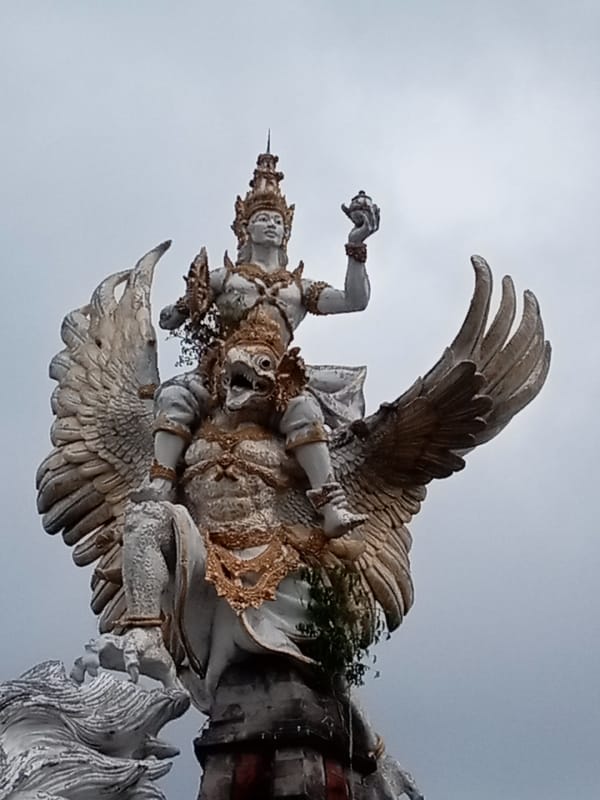 Ornate statues and mythical figures at a Southeast Asian monument complex
