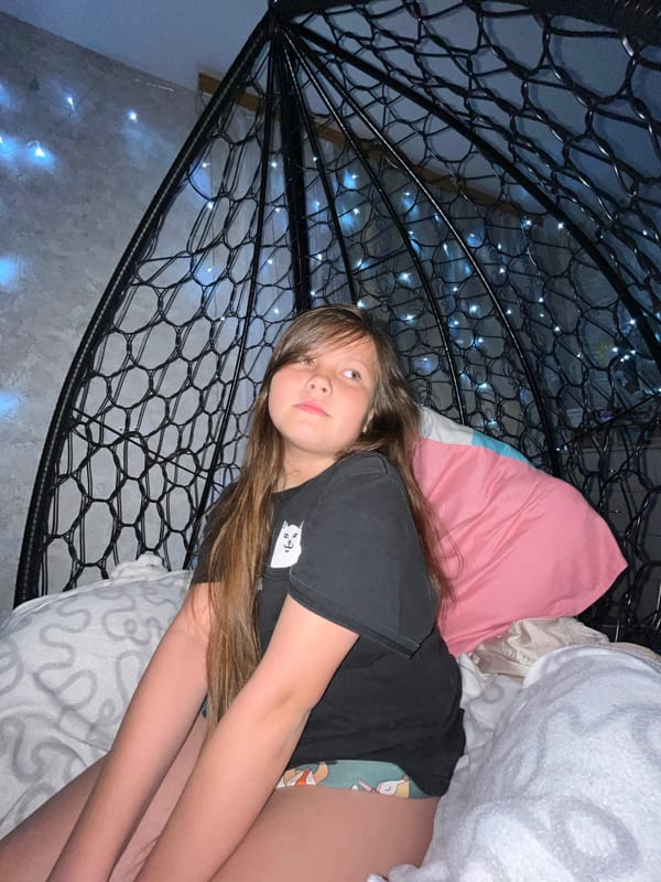 Young woman photographed in relaxed indoor poses in Novopokrovskaya