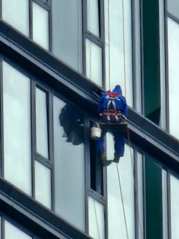 Rope work on a Moscow glass tower, multiple angles
