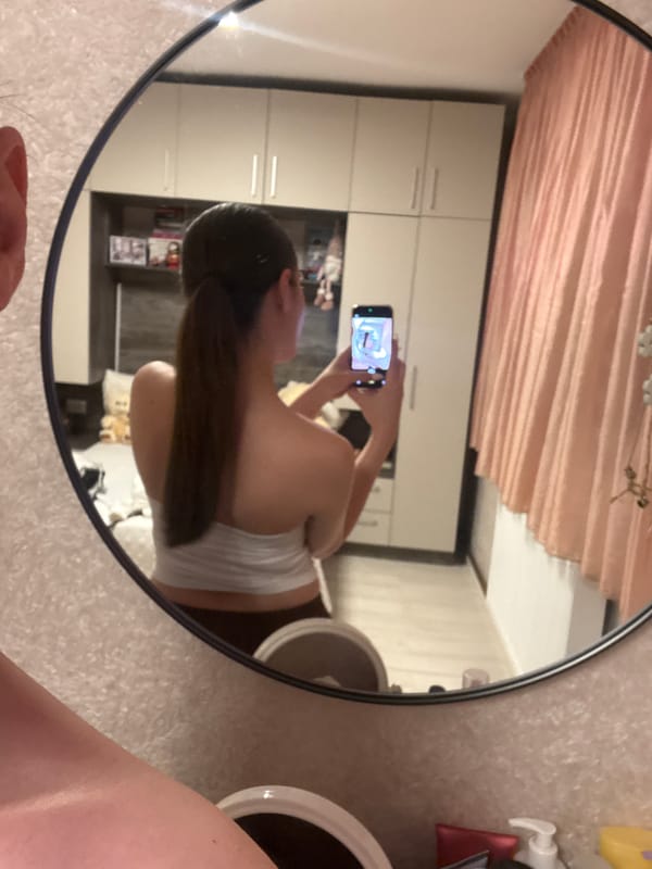 Woman takes mirror selfies in Bulgarian apartment