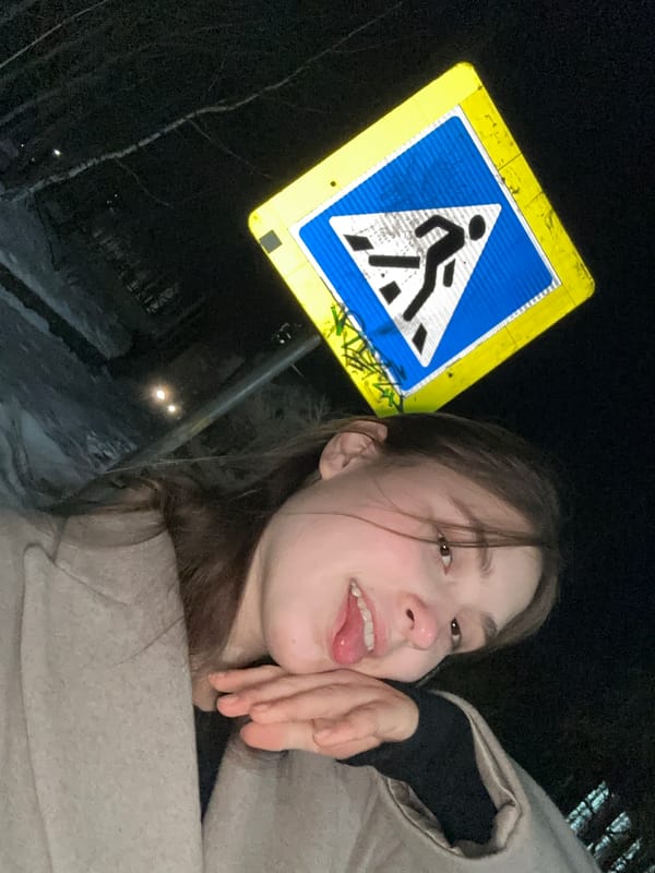 Woman poses with pedestrian crossing sign in Sarapul
