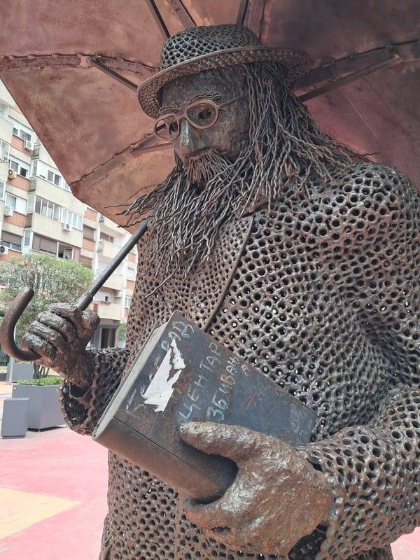 Belgrade chainmail sculpture of a figure with umbrella and book