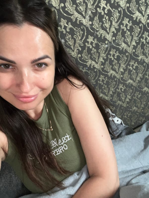 Lazy morning in bed, green tank top, sleepy dog included