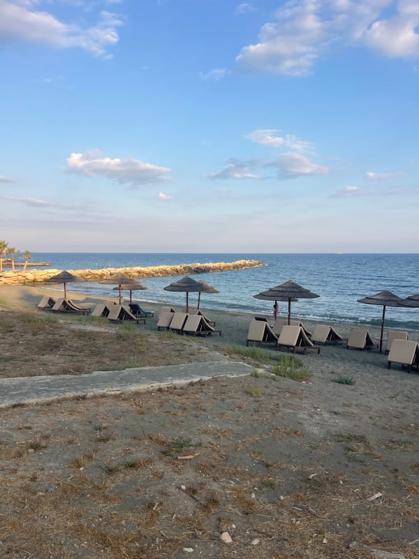 Cyprus coastal promenade with beach, gardens, and offshore water park