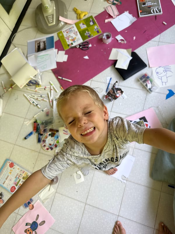 Child enjoys art time on floor in Thailand