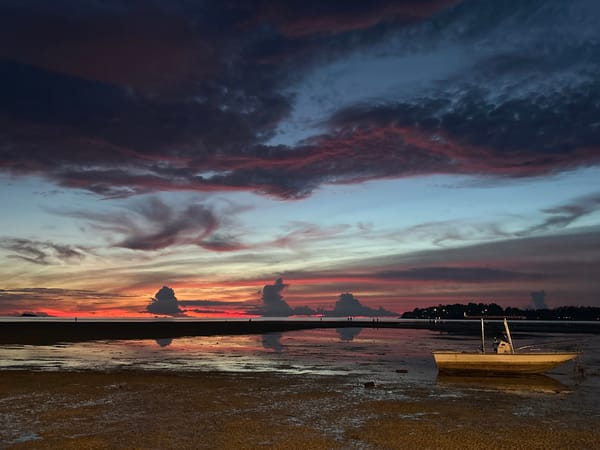 Sunset low tide on Koh Phangan beach, boats and people in frame