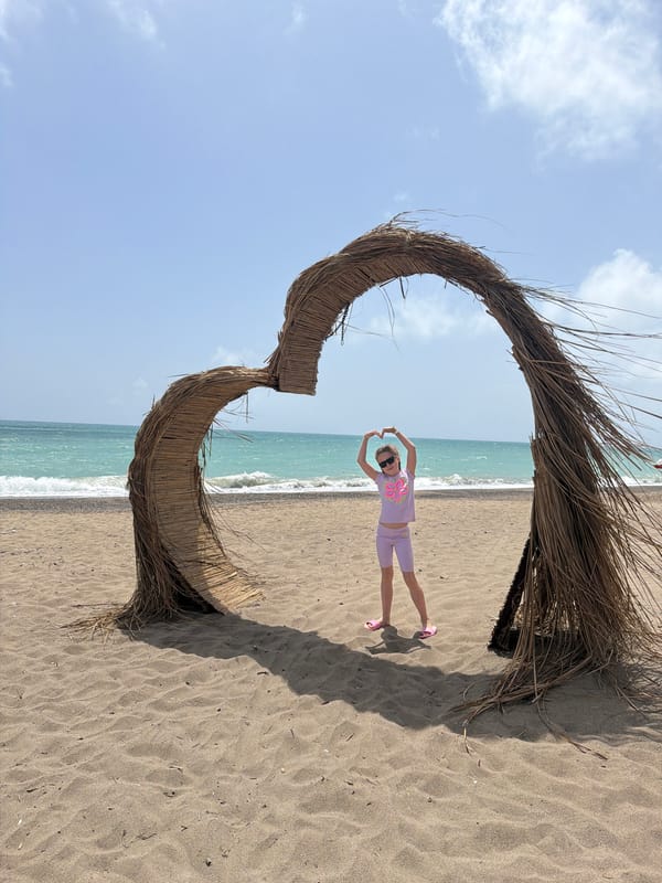 Girl poses in heart structure on Turkish beach