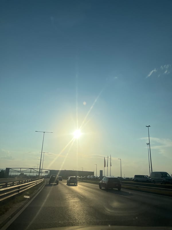 Rolling highway footage, sun out, mixed traffic moving along