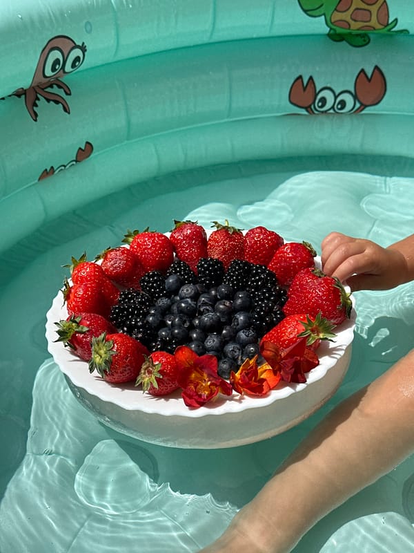Toddler enjoys pool time with fresh berries in Wisła