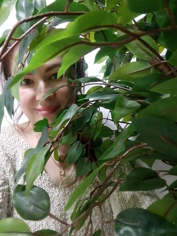 Woman takes multiple selfies indoors in Chaikovsky, Russia