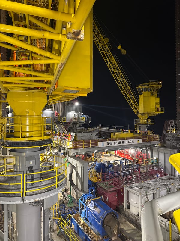 Offshore oil rig operations documented at night in Italy
