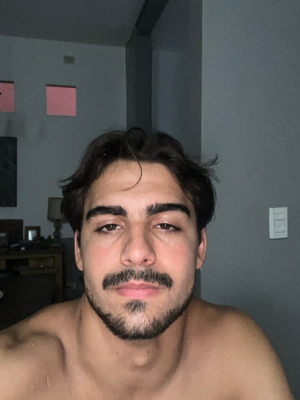 Man takes selfies indoors in Avellaneda apartment