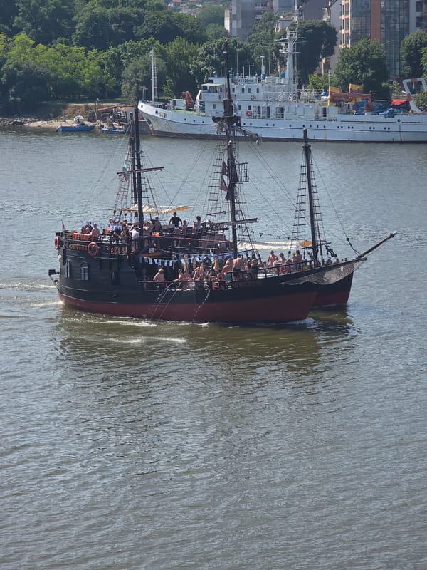 Pirate tourist boats cruise Varna Bay near working port