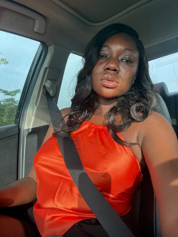Woman in orange top observed in passenger seat, Kuchingoro