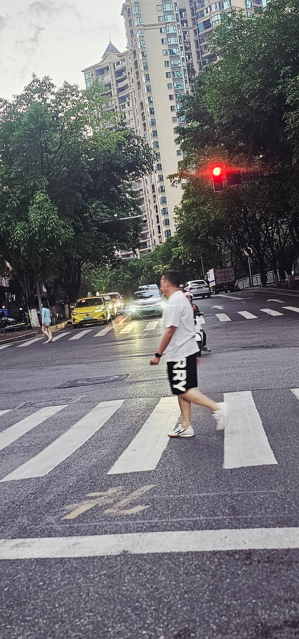 Pedestrians cross street at Chongqing intersection during red light