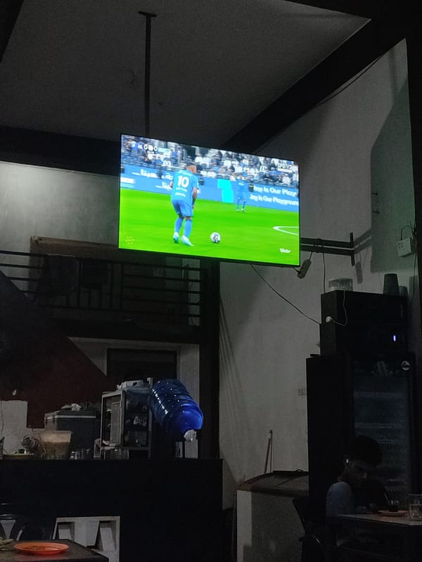 Soccer match broadcast viewed at Indonesian cafe