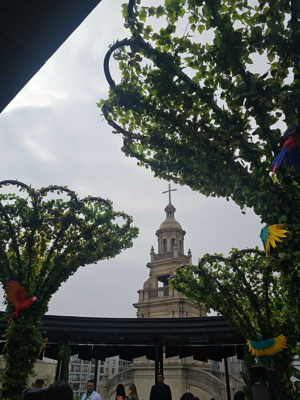 Rooftop dining view captures church tower in San Isidro