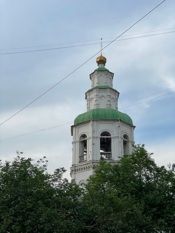 Food vendors operate near historic architecture in Krasnoyarsk