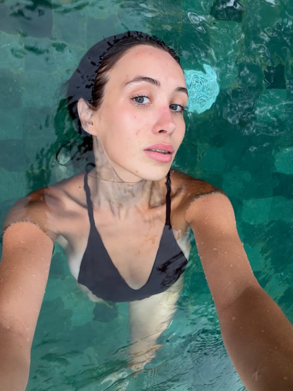 Woman floats peacefully in pool in Ubud, Indonesia