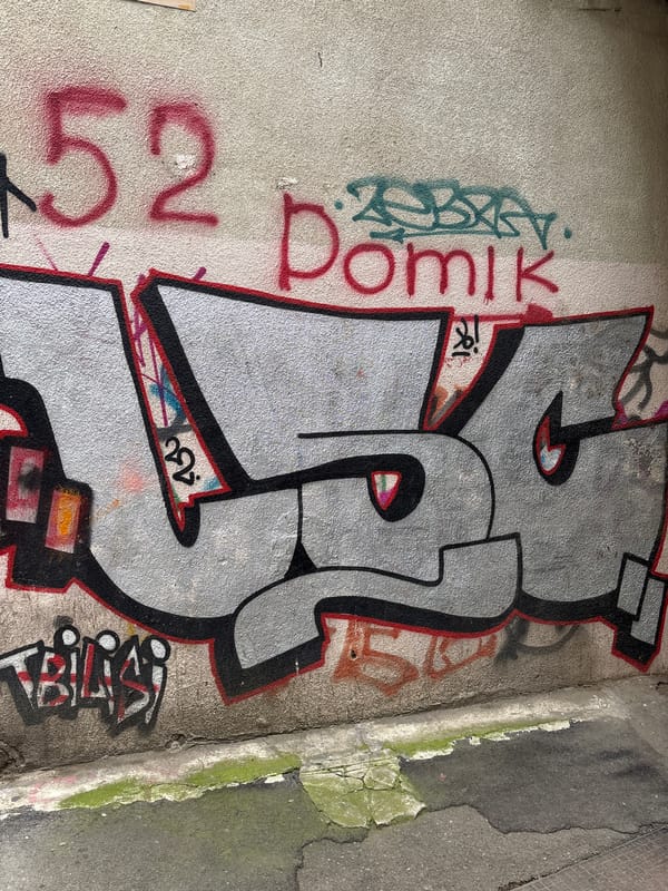 Graffiti-heavy urban walkthrough with Borjomi cable cars in the mix