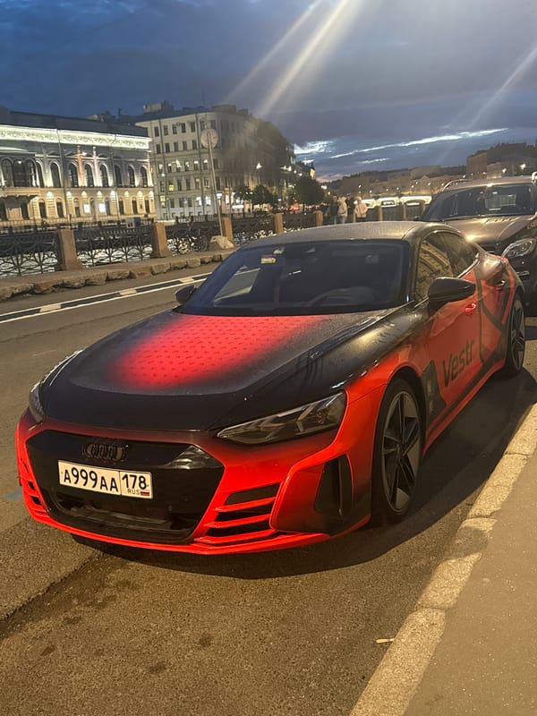 Late-night Saint Petersburg: cars, a night rider, and classic facades