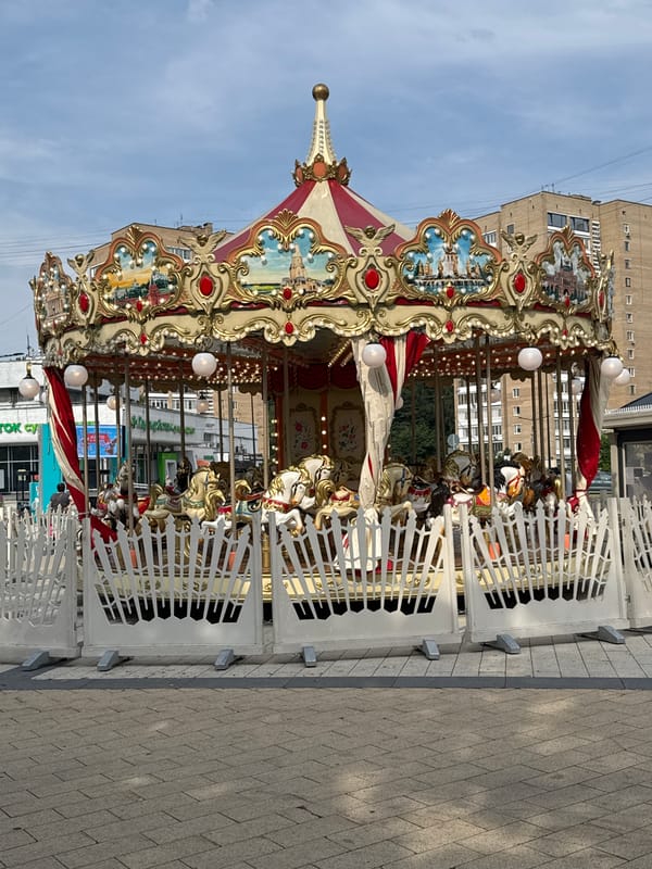 Elaborately decorated carousel running in a Zelenograd urban plaza