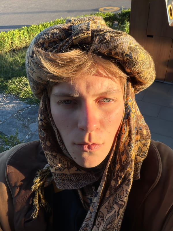 Portrait captured of person in brown headscarf at coordinates 666