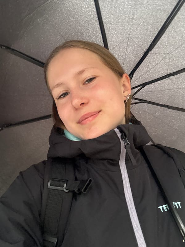 Woman photographed under umbrella during cloudy night in Chaikovsky