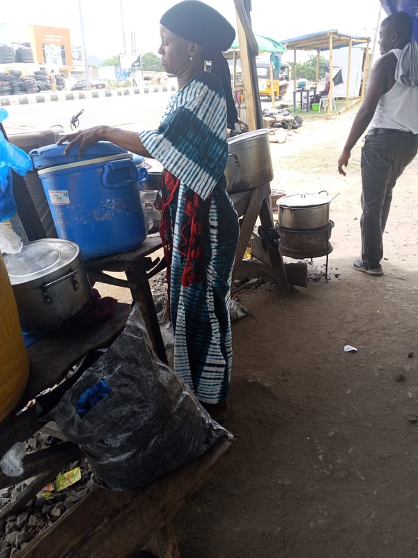 Woman prepares food at cooking station in Lokoja, Nigeria