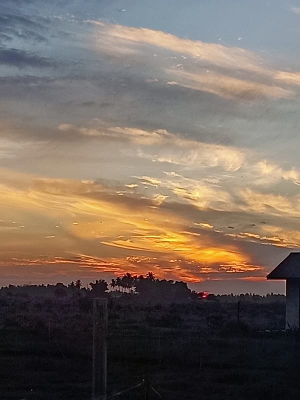 Golden sunset settles over rural Aceh villages at dusk