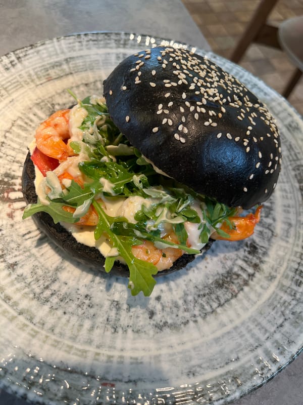 Diner documents gourmet burger lunch at urban restaurant
