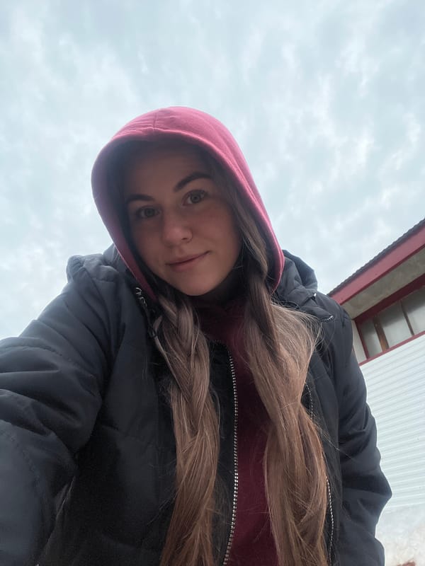 Woman takes multiple selfies on overcast day in Chaikovsky