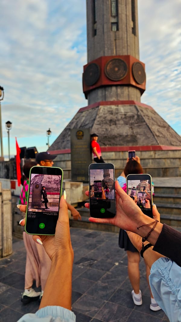 Tourists photograph octagonal monument in Lũng Cú Commune