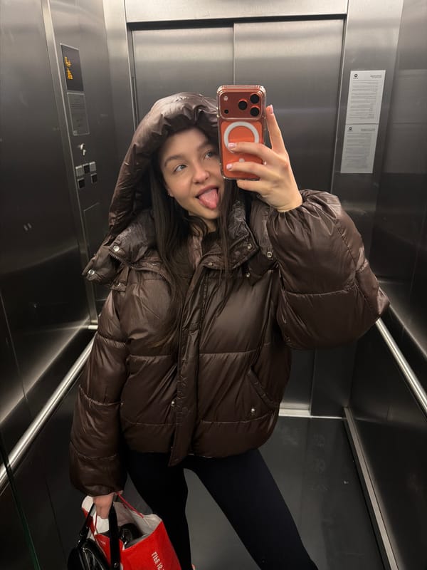 Person takes playful tongue-out selfie in Sofia elevator