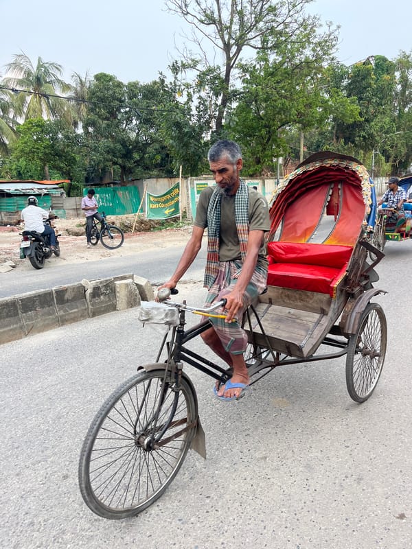 Morning street commerce bustles across Dhaka with vendors and rickshaws