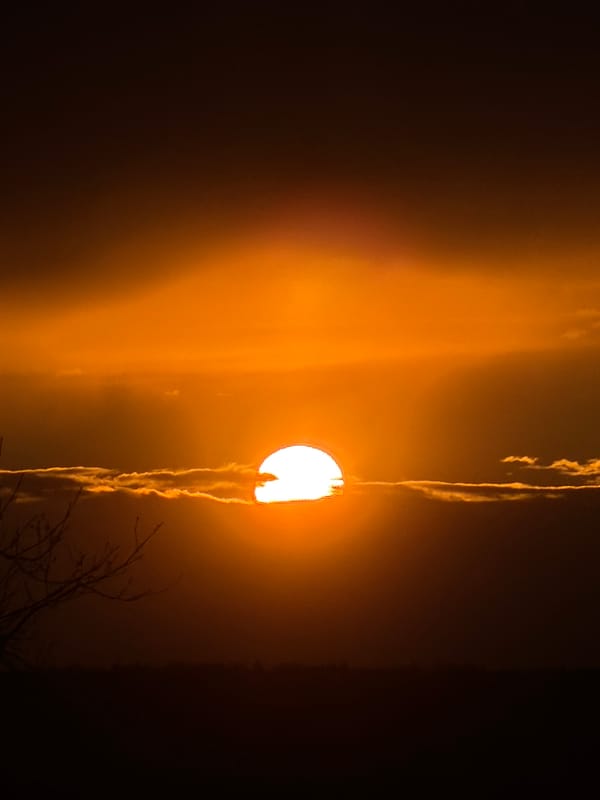 Dramatic sunset and visible moon captured in Chaikovsky, Russia