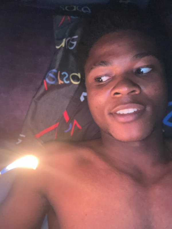 Flame-lit selfie session in a dim room, Ihiagwa