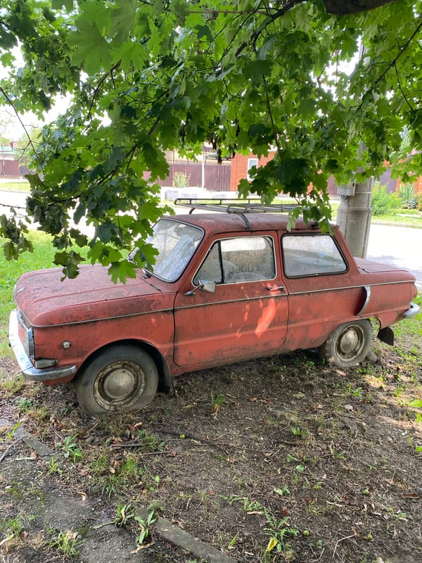 Parked cars along Maykop streets, one seriously weathered